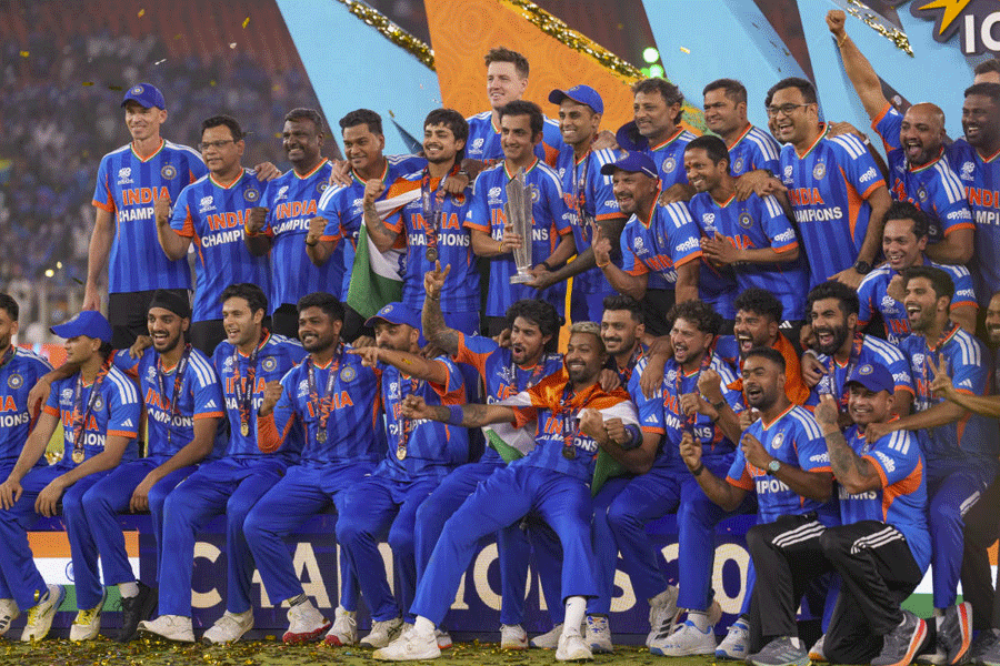India's captain Suryakumar Yadav, head coach Gautam Gambhir and other team members celebrate with the tournament trophy during the presentation ceremony after winning the ICC Men's T20 World Cup 2026, at Narendra Modi Stadium, in Ahmedabad, Gujarat, Sunday, March 8, 2026.