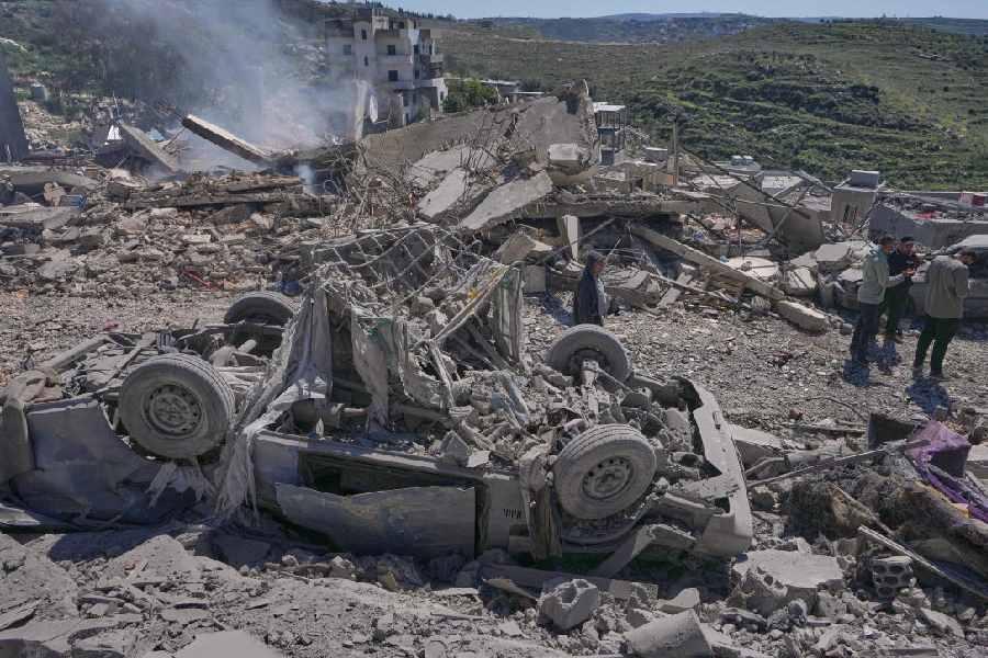 eople check the site where Israeli airstrikes hit several houses in Sir al-Gharbiyeh village south Lebanon, Sunday, March, 8, 2026