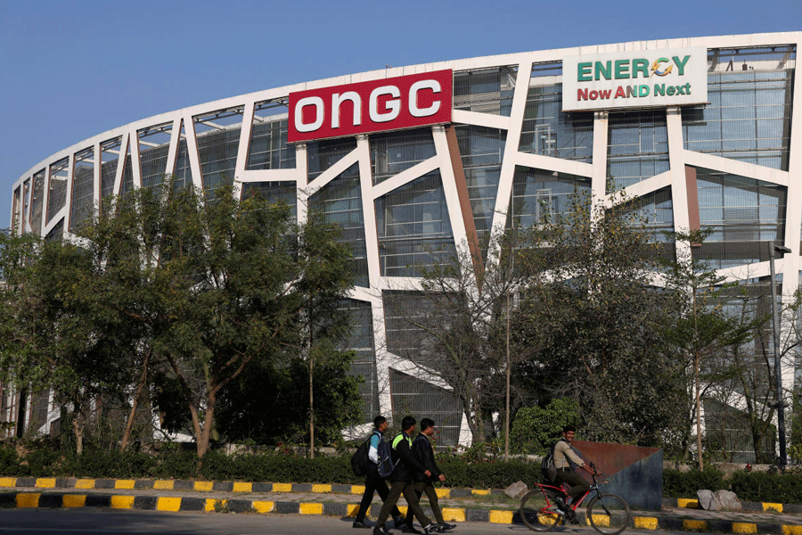 People pass by in front of the Oil and Natural Gas Corporation Limited (ONGC) office in New Delhi, India, March 3, 2026.