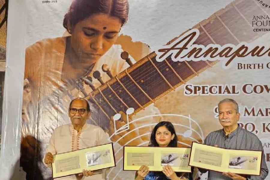 Director, postal services, Calcutta, Sukriti Gupta (centre), flanked by Annapurna Devi Foundation trustees and her disciples Basant Kabra (left) and Nityanand Haldipur,            releases the special cover on the birth centenary at the General Post Office on Monday. Pictures by Sudeshna Banerjee