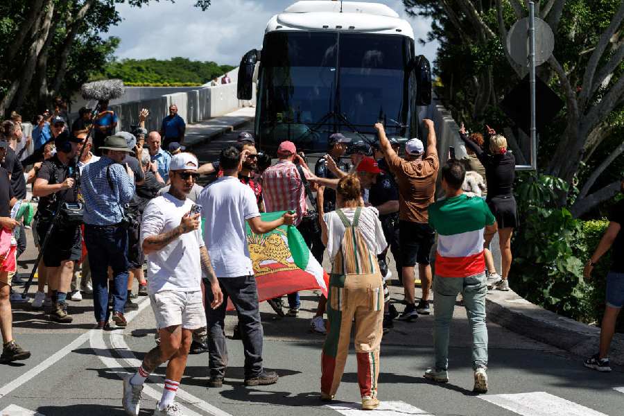 Protesters demonstrate outside of Royal Pines resort as a bus carrying players from the Iranian women's soccer team and staff departs, after five Iranian women soccer players were granted humanitarian visas, on the Gold Coast, Queensland, Australia, March 10, 2026