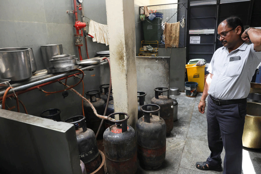 An employee stands near empty LPG cylinders inside Vidyarthi Bhavan restaurant, as restaurants and hotels in southern India, including the IT hub of Bengaluru, have warned of shutdowns amid disruptions in commercial LPG supply, following the U.S.-Israeli conflict with Iran, in Bengaluru, India, March 10, 2026.