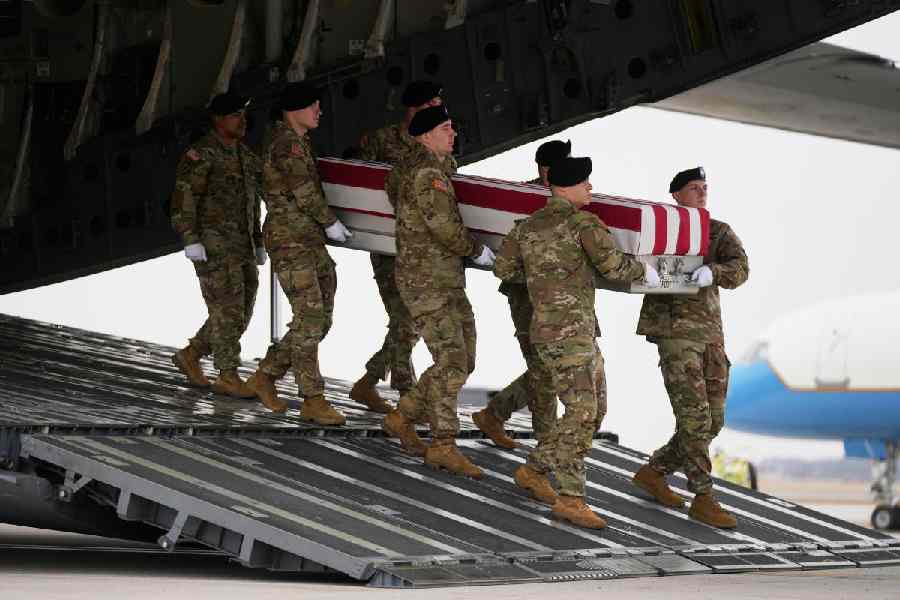 An Army carry team moves a flag-draped transfer case with the remains of Sgt. Declan Coady, 20, of West Des Moines, Iowa, who was killed in a drone strike at a command center in Kuwait.