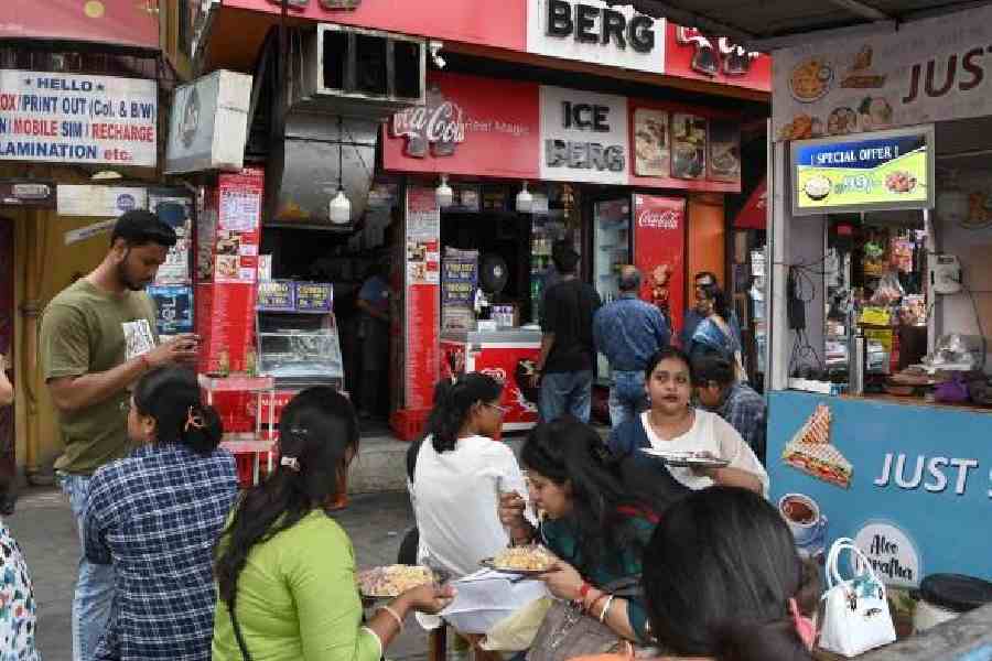 Diners at roadside eateries in Gariahat on Tuesday afternoon. Picture by Sanat Kr Sinha