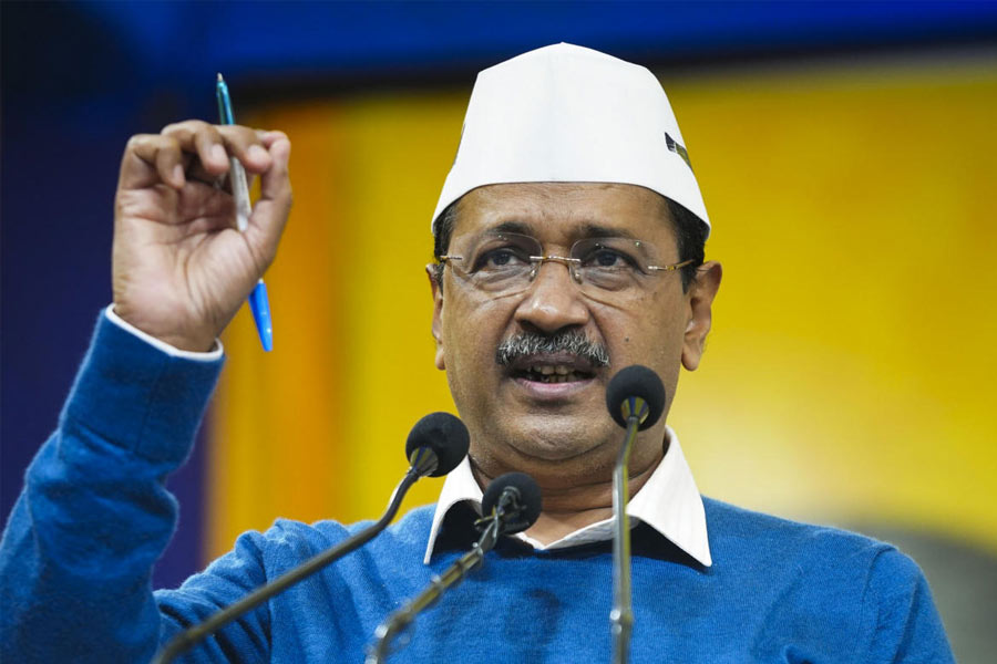 A worker sits over LPG cylinders during distribution at a gas agency, in Chikkamagaluru, Karnataka, Wednesday, March 11, 2026. Long queues were seen at several gas agencies amid an ongoing LPG supply shortage in the country.