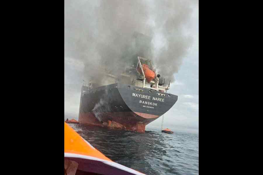 The Thai-flagged ship Mayuree Naree engulfed in smoke on Wednesday. 