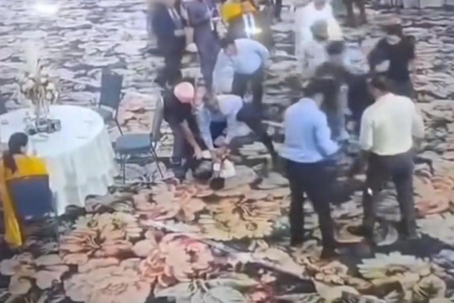 Kamal Singh Jamwal who allegedly fired a shot targeting National Conference president Farooq Abdullah and Jammu and Kashmir Deputy Chief Minister Surinder Choudhary at a wedding function, being detained by people before being handed over to security personnel, in Jammu, Wednesday, March 11, 2026.