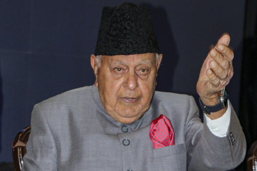 Kamal Singh Jamwal who allegedly fired a shot targeting National Conference president Farooq Abdullah and Jammu and Kashmir Deputy Chief Minister Surinder Choudhary at a wedding function, being detained by people before being handed over to security personnel, in Jammu, Wednesday, March 11, 2026.