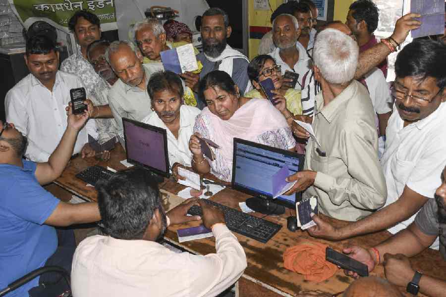 People gather to book LPG cylinders at an Indane gas agency, in Prayagraj, Uttar Pradesh, Thursday, March 12, 2026
