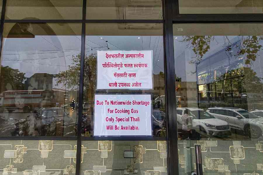 A notice about the nationwide shortage of cooking gas is displayed outside a restaurant at APMC, in Navi Mumbai 