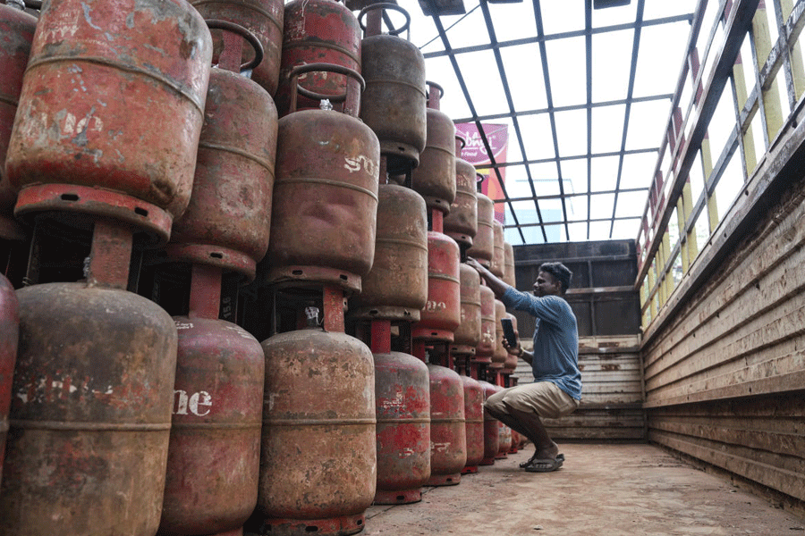 A worker arranges LPG cylinders on a truck amid reports of cooking gas shortage, in Kolkata, Wednesday, March 11, 2026.