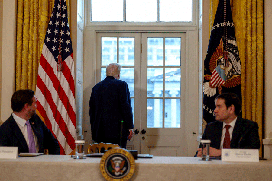 FILE PHOTO: U.S. President Donald Trump looks towards the site of the demolished East Wing of the White House, the future sight of Trump's ballroom, as he attends a meeting with oil industry executives, at the White House in Washington, D.C., U.S., January 9, 2026.