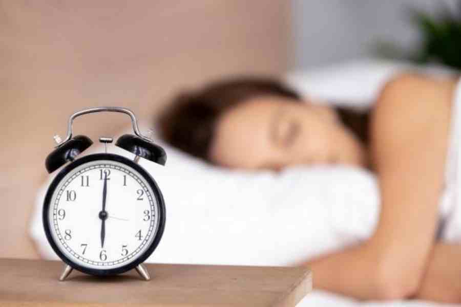 Use an alarm clock to mark the time to go to bed, not wake up