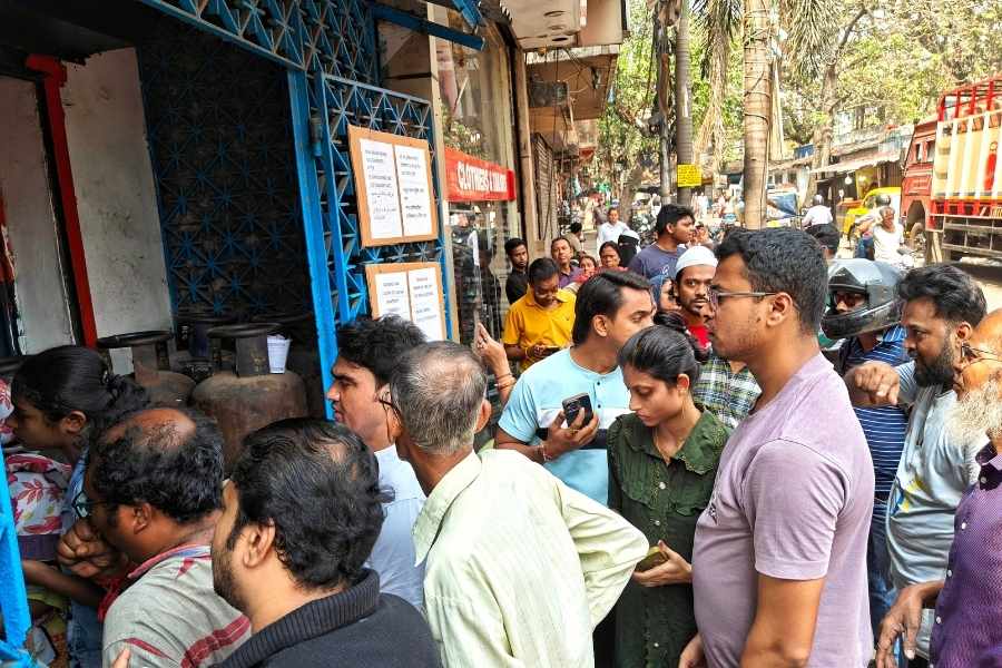 People wait in line at a gas distribution centre at Entally 