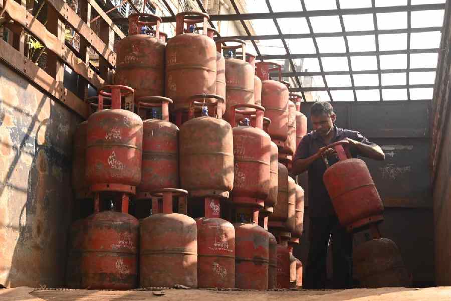 A worker loads LPG cylinders onto a truck at Raja Rammohan Roy Sarani in Calcutta on Friday.