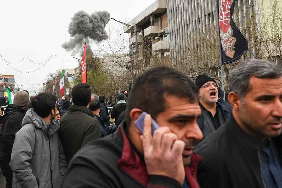 Smoke from an explosion rises in Tehran during an anti-Israel rally on Friday.
