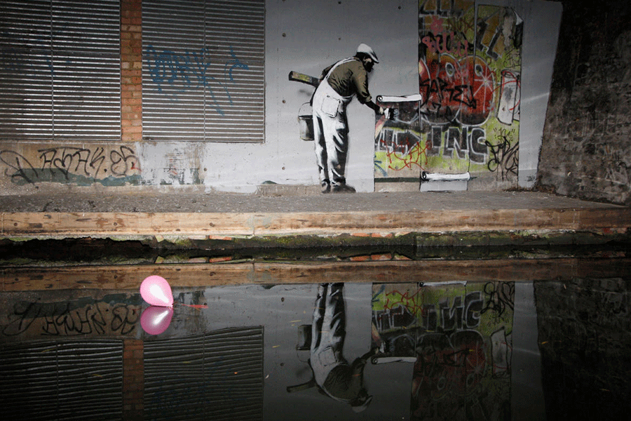 Graffiti art is seen on a wall next to the Regent's Canal in Camden in London