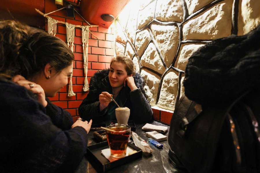 Women chat at a cafe amid heightened tensions linked to the US-Israeli conflict with Iran, in Tehran, Iran, March 13, 2026.