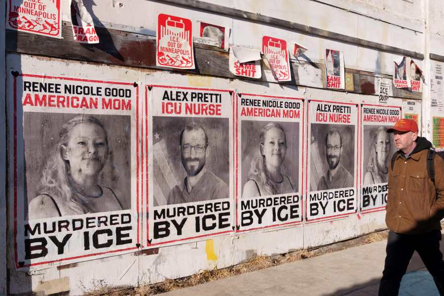 Posters showing Renee Good and Alex Pretti cover the wall of a building along East Lake Street in Minneapolis, Minnesota, U.S., March 11, 2026.