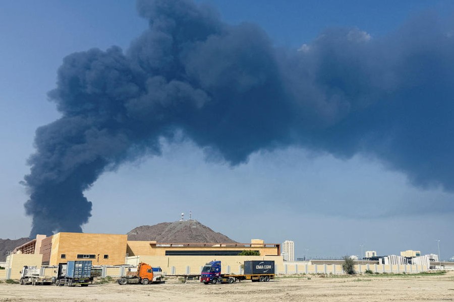 Smoke rises in the Fujairah oil industry zone, caused by debris after interception of a drone by air defenses, according to the Fujairah media office, amid the U.S.-Israel conflict with Iran, in Fujairah, United Arab Emirates, March 14, 2026.