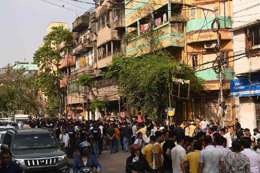 A crowd outside minister Shashi Panja’s home (yellow and green) after it was attacked on Saturday. 
