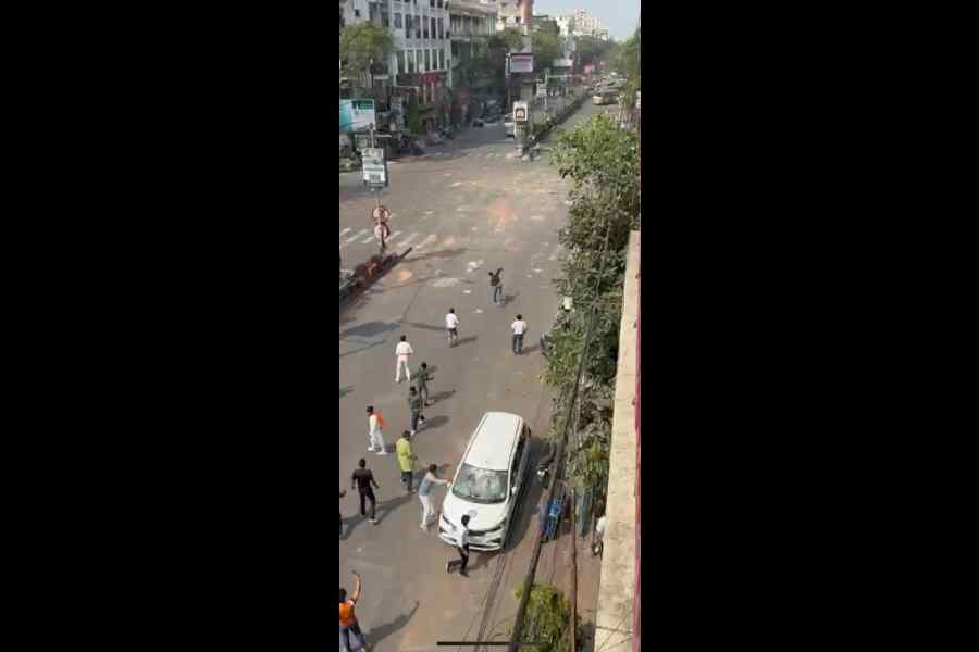 Vandals target a police car and hurl stones during the clash on Saturday