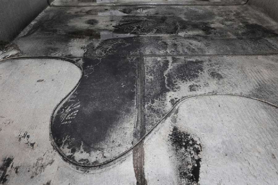 Black soot on the floor after reported black rain following a strike on fuel tanks, amid the U.S.-Israeli conflict with Iran, in Tehran, Iran