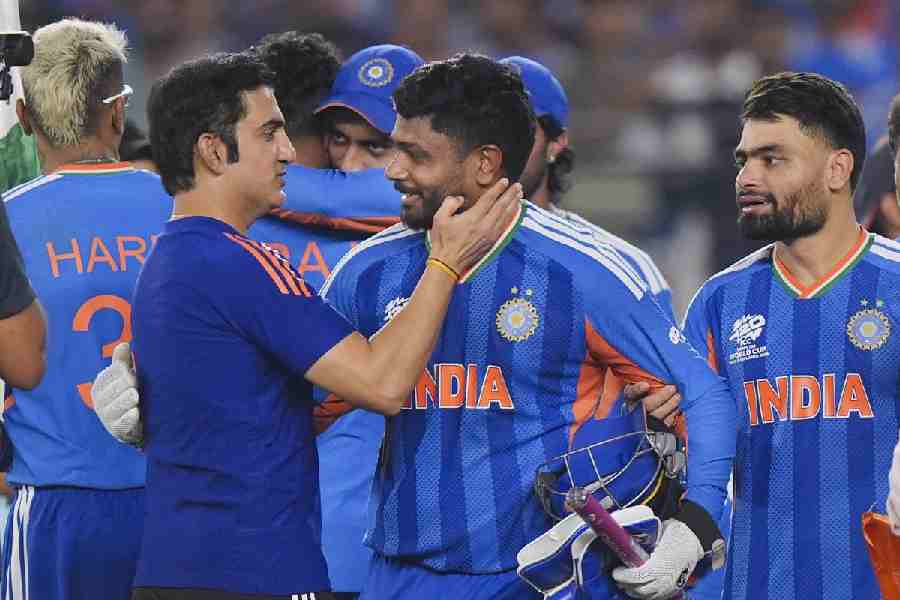 India's wicketkeeper Sanju Samson, front centre, being congratulated by head coach Gautam Gambhir, front left, after winning the ICC Men's T20 World Cup 2026 final cricket match between India and New Zealand, at Narendra Modi Stadium, in Ahmedabad, Gujarat, Sunday, March 8, 2026.