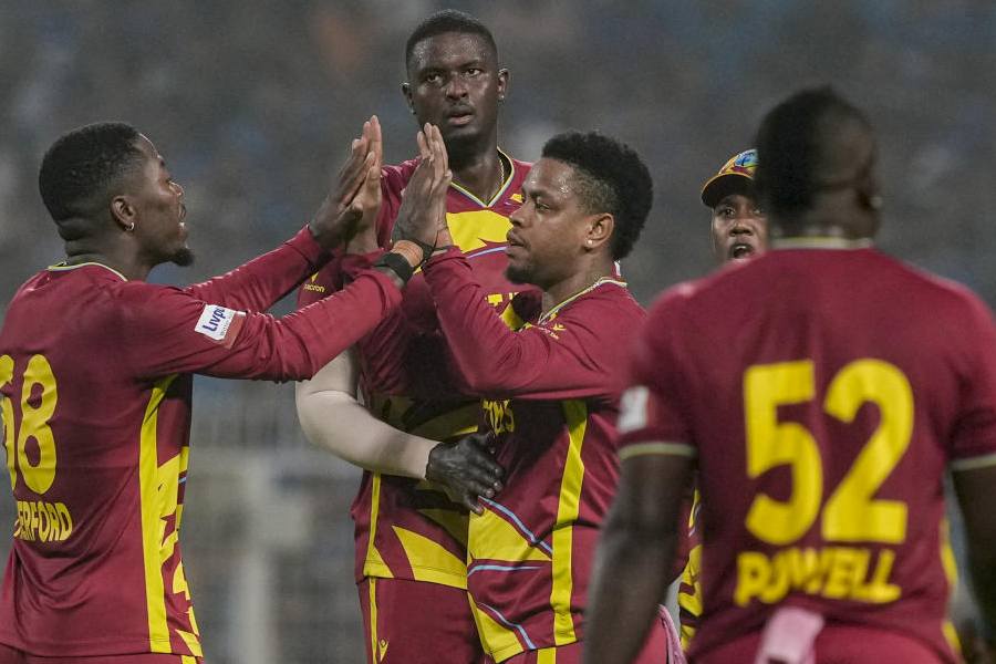 West Indies' Jason Holder with teammates celebrates after taking the wicket of India's Tilak Varma during the ICC Men's T20 World Cup 2026 cricket match between India and West Indies, at the Eden Gardens, in Kolkata, West Bengal, Sunday, March 1, 2026.