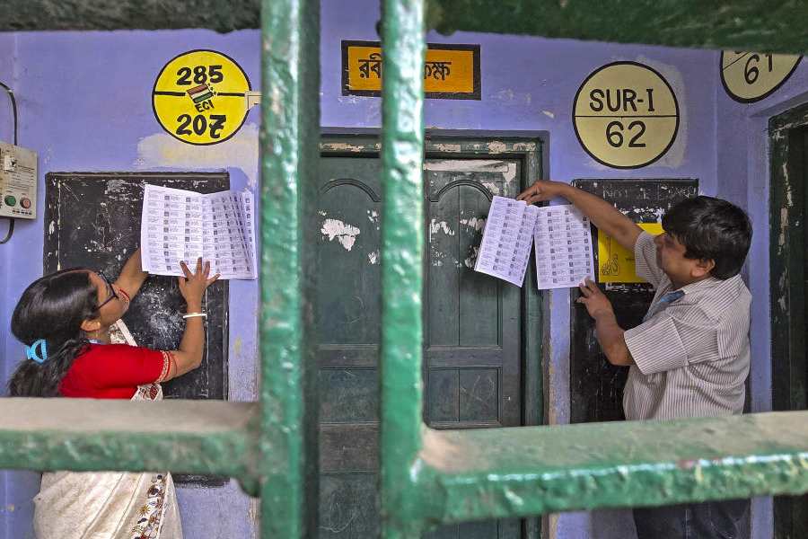 Booth-level officers hang voters' list after the publication of the post-Special Intensive Revision (SIR) electoral rolls, in Birbhum, West Bengal, Sunday, Mar. 1, 2026.