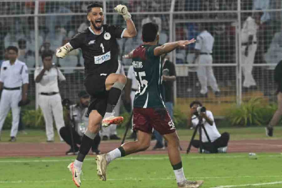Mohun Bagan's Vishal Kaith and  Mehtab Singh (right) celebrate the IFA Shield triumph over Emami East Bengal on October 18, 2025. File picture