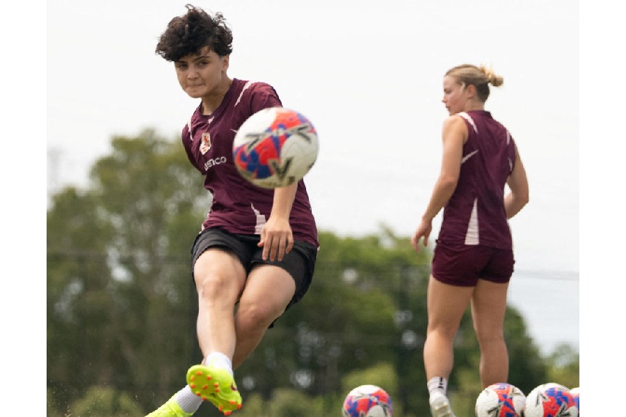 Iranian soccer player Fatemeh Pasandideh kicks a ball 
