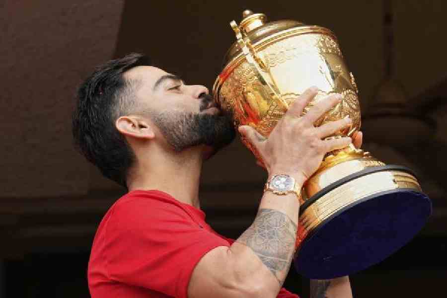 Virat Kohli with the IPL trophy at the Chinnaswamy last June. (AP/PTI)