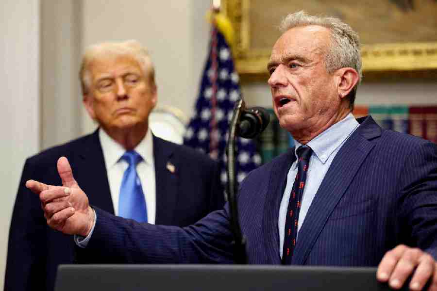US Secretary of Health and Human Services Robert F. Kennedy Jr. delivers remarks while U.S. President Donald Trump listens during a press conference to announce a link between autism and childhood vaccines and the use of popular pain medication Tylenol for pregnant women and children, claims which are not backed by decades of science, at the White House in Washington, D.C., US, September 22, 2025.
