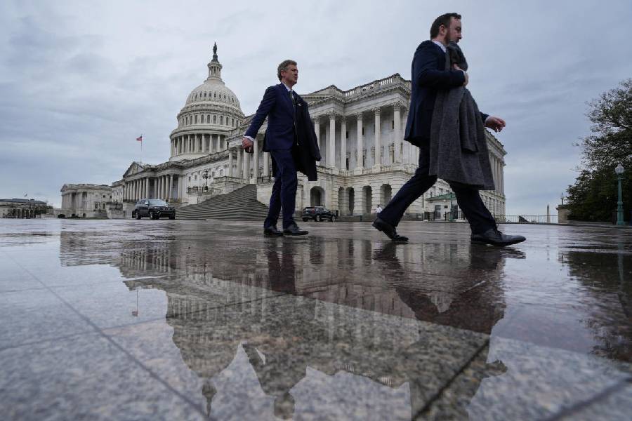 People walk past US Capitol after rain amid severe weather forecast in Washington DC