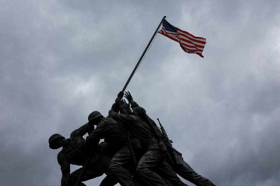 US flag flies near Marine Corps War Memorial as storm clouds gather in Washington DC