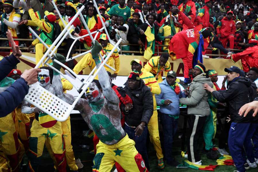 Senegal fan clashes with security as fans invade the pitch after Morocco were awarded a penalty following a VAR review on January 18, 2026.