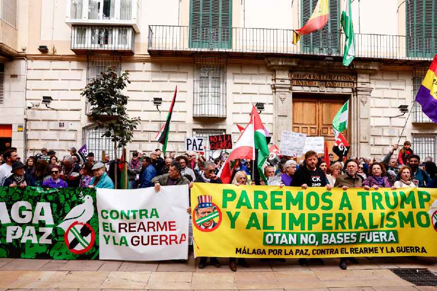 People hold banners at a protest calling for an end to hostilities amid the US-Israeli conflict with Iran, in Malaga, Spain, March 7.