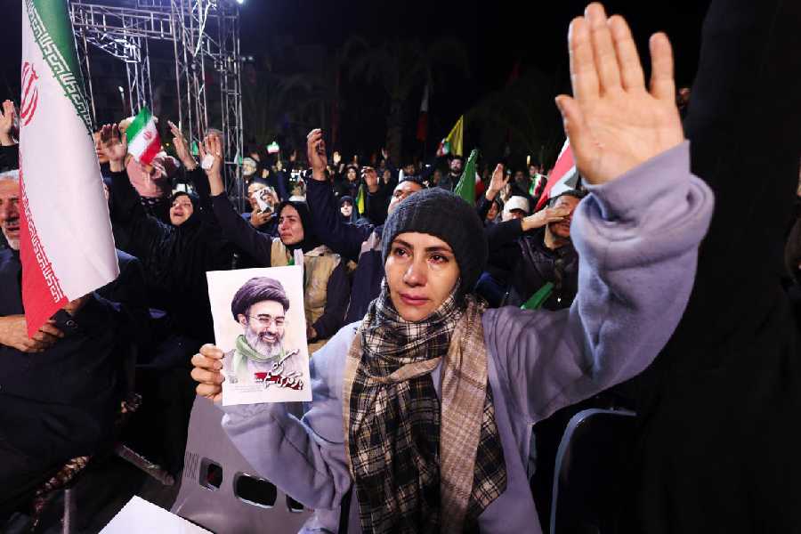 Woman holds Mojtaba Khamenei poster at Tehran anti-US rally