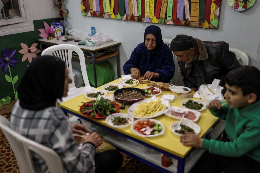 Displaced people break their fast at iftar during Ramadan inside a Beirut school converted into a shelter, following an escalation between Hezbollah and Israel