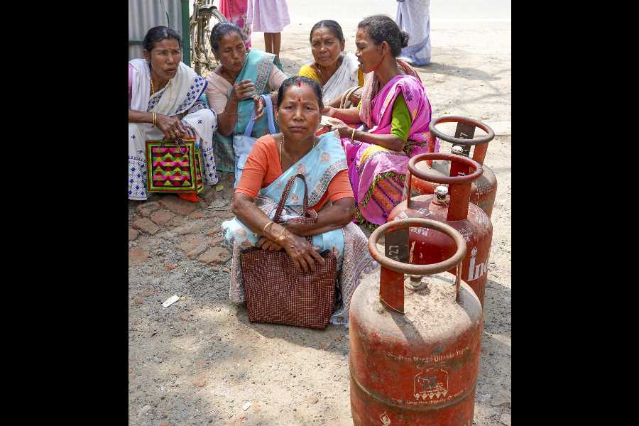 Women queue with LPG cylinders during supply crisis in Morigaon