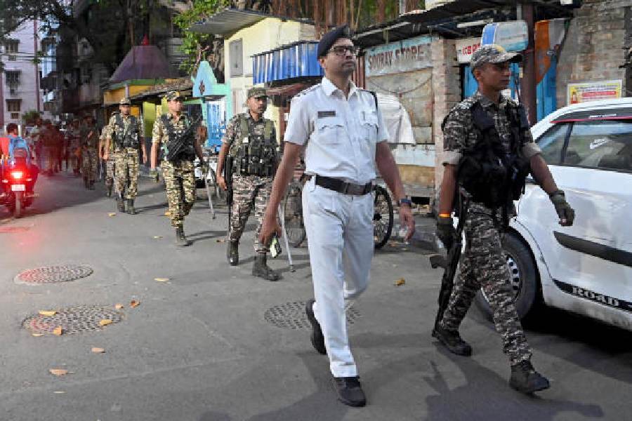 CRPF jawans, along with an officer from the city police, conduct a route march in the Jodhpur Park area on Thursday evening.