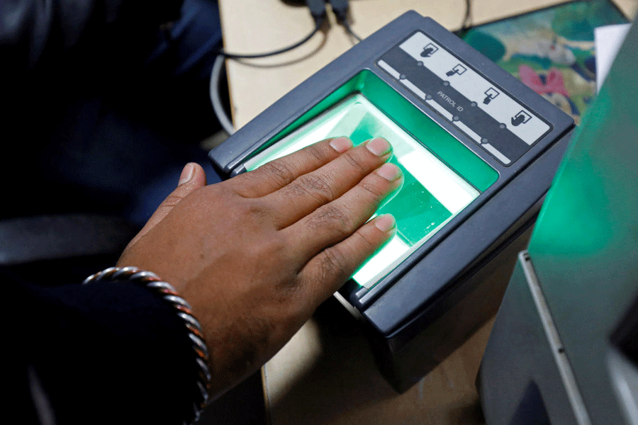 FILE PHOTO: A woman goes through the process of finger scanning for the Unique Identification database system, also known as Aadhaar, at a registration centre in New Delhi