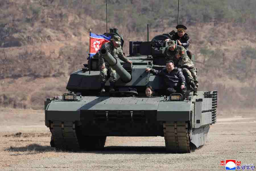 North Korean leader Kim Jong Un and his daughter Kim Ju Ae ride a tank during what North Korean state news agency KCNA reports is an offensive tactical drill involving a new type of tank, at a training base in Pyongyang, North Korea, March 19, 2026, in this picture released by North Korea's official Korean Central News Agency.