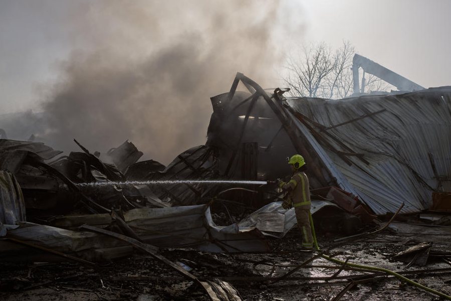 A firefighter works to extinguish a fire at the site of a direct hit from an Iranian missile in central Israel, Wednesday, March 18, 2026.