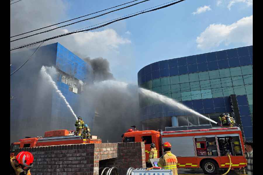 Firefighters try to extinguish the fire at a car parts factory in Daejeon, South Korea