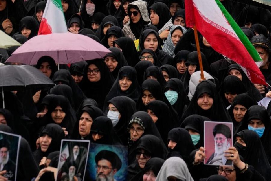 Iranians attend the funeral procession of Iran's intelligence minister Esmail Khatib and, according to Iranian officials, his wife and daughter, in Tehran, Iran, Friday, March 20, 2026.