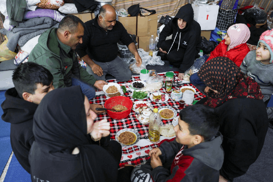 Shi'ite displaced people from South Lebanon eat a meal as they take shelter in a Shi’ite religious centre, on the day of Eid al-Fitr, marking the end of the holy fasting month of Ramadan, following an escalation between Hezbollah and Israel amid the U.S.-Israeli conflict with Iran, in Sidon, Lebanon, March 20, 2026. 