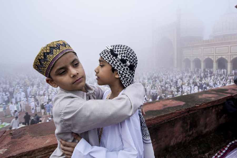 Children from the Muslim community exchange greetings at Jama Masjid on the occasion of Eid Al-Fitr, in New Delhi, Saturday, March 21, 2026. 