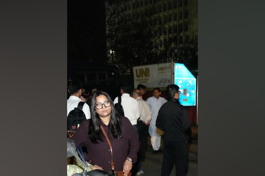 Media representatives and employees outside the United News of India’s (UNI) office after it was sealed, citing a high court order, even as the media organisation termed the action an "attack on press freedom", in New Delhi, Friday, March 20, 2026.